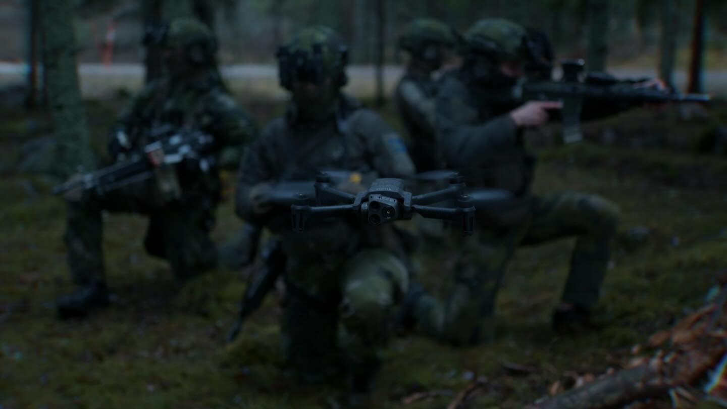 Military drone team training with an aerial drone